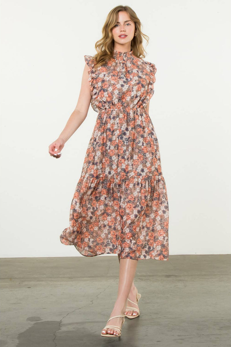 Woman wearing a floral dress on a plain background