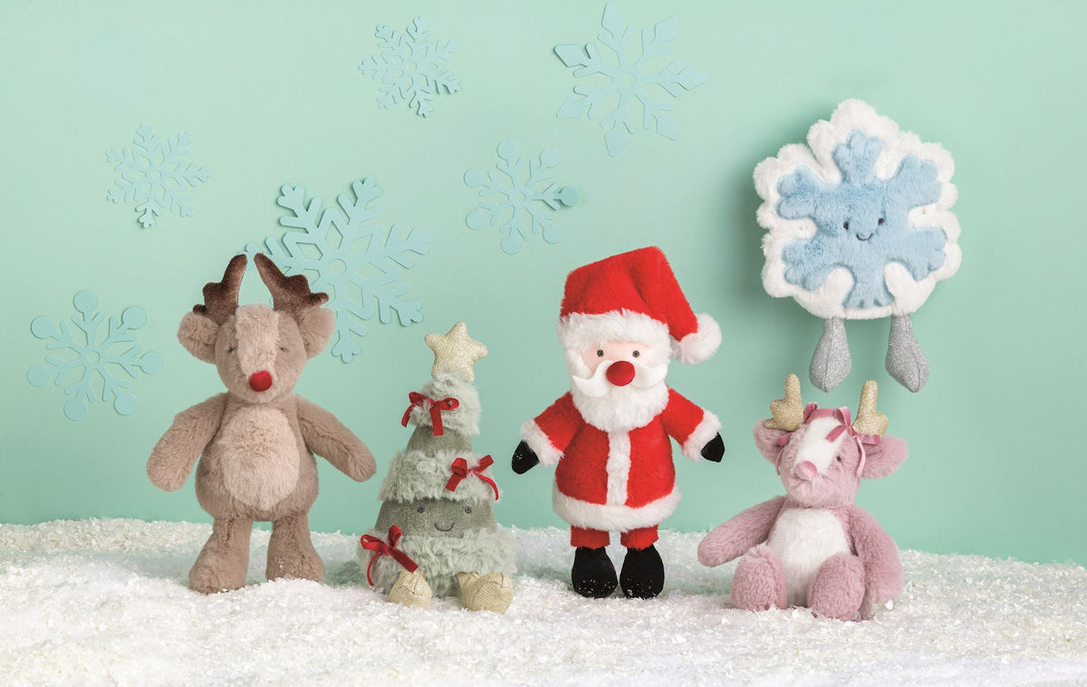 Mud Pie Mini Christmas Plush Pals styled in snow with reindeer, tree, Santa and snowflake