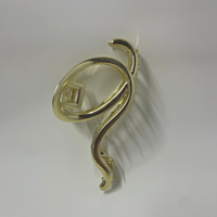Gold hair clip with a unique design on a white background