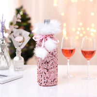 Rose gold sequin Christmas wine bottle cover with white faux fur trim and ribbon bow