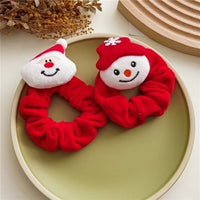 Red velvet hair scrunchie with a cute plush snowman charm
