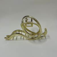 Gold hair clip on a white background