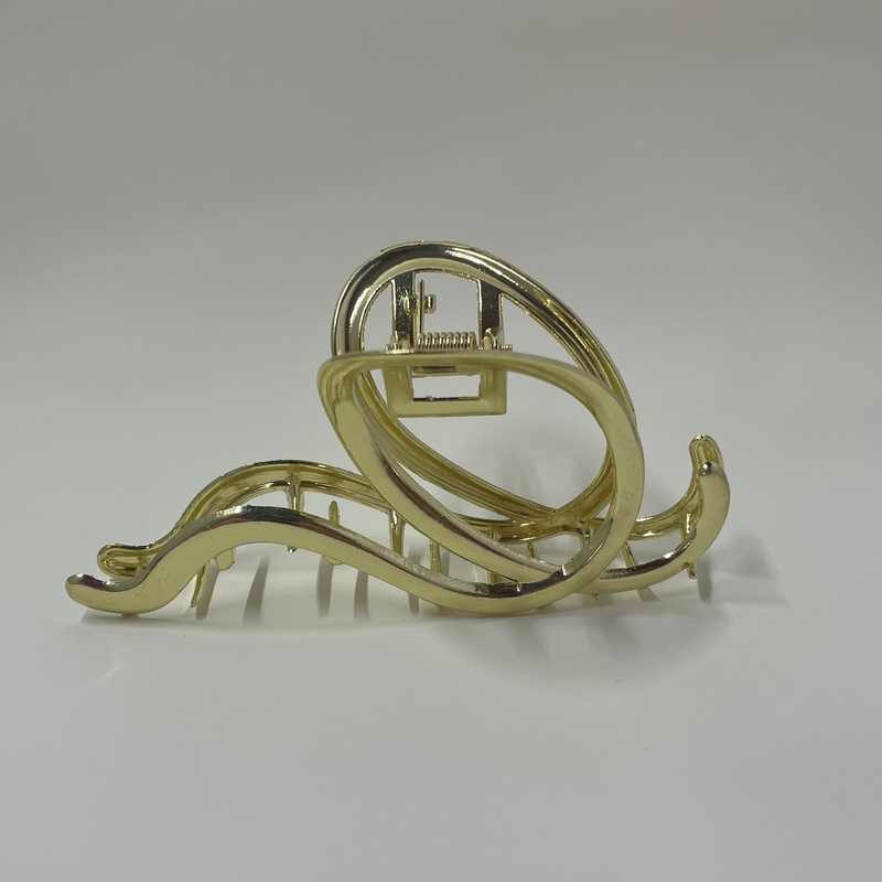 Gold hair clip on a white background