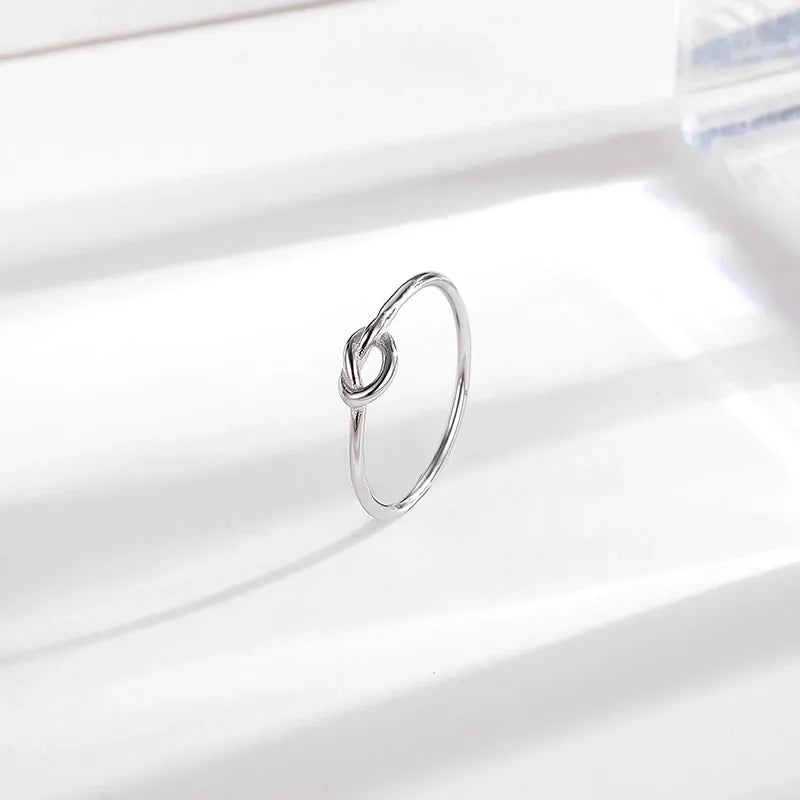 Silver titanium steel minimalist knot ring with a high-polished finish