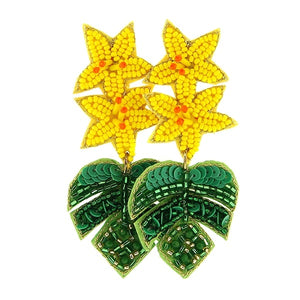 Dangle earrings with two yellow flowers with monstera leafs underneath