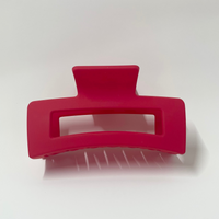 Red hair clip on a white background
