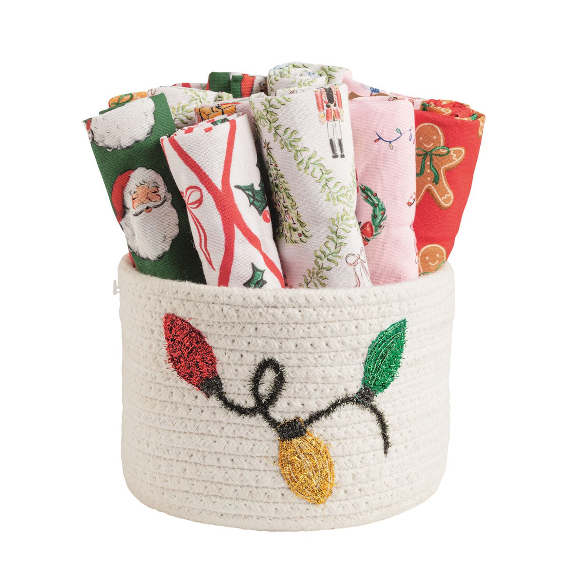 Mud Pie assorted patterned Christmas towels in a beaded cotton rope basket