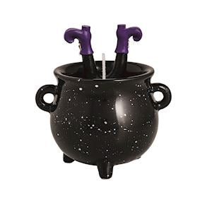 Black cauldron with purple witch boots on a white background