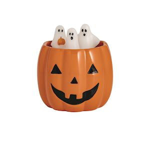 Hand-painted ceramic jack-o'-lantern candle jar holding four white ghost-shaped wax figures