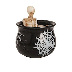 Black cauldron with spider webs and a skeleton figure on a white background