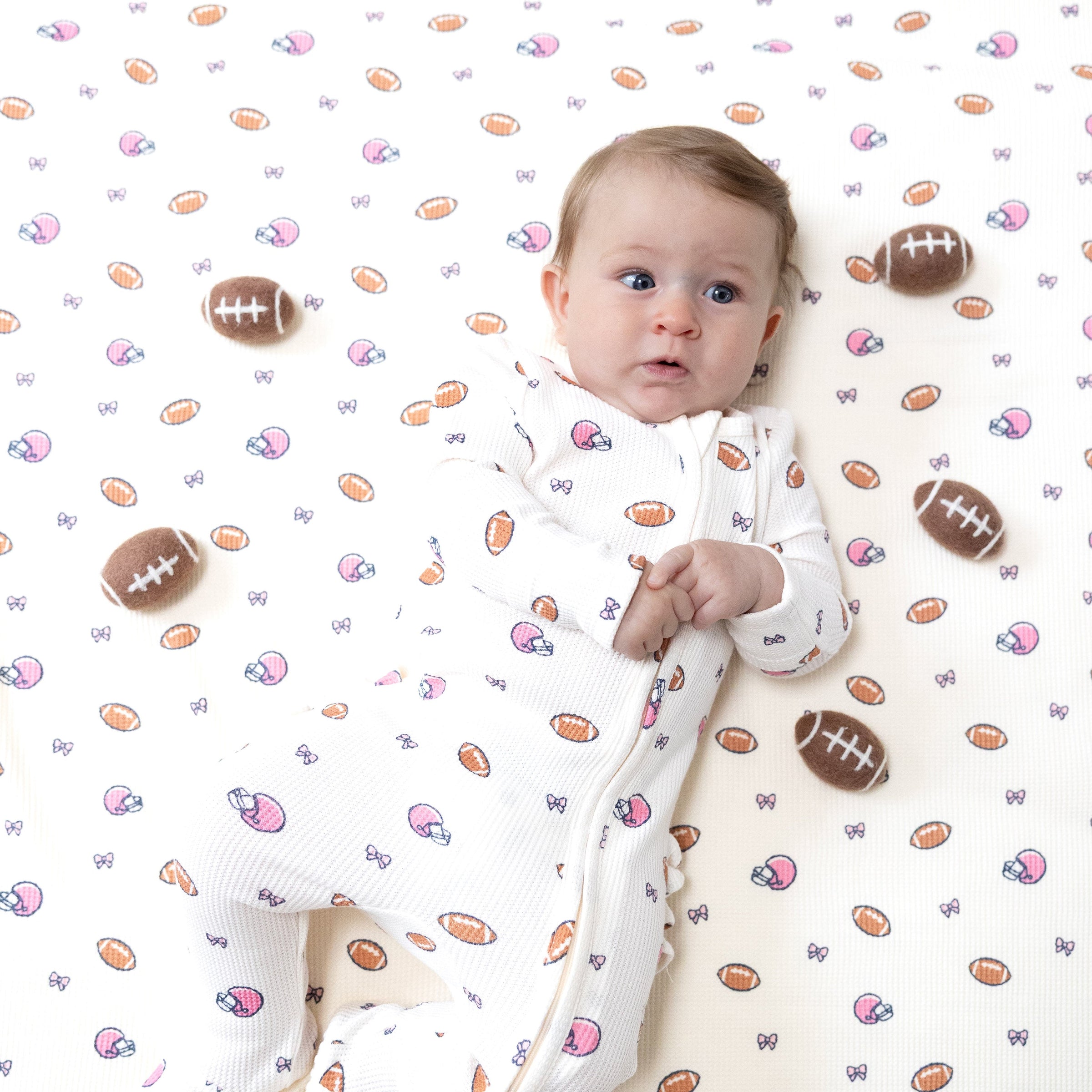 Footballs and Bows - 2 Way Zipper Ruffle Back Footie