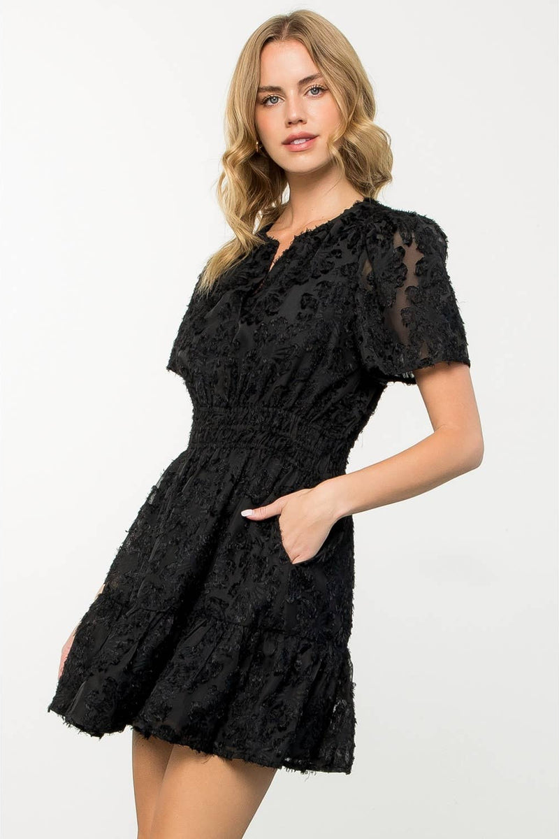 Woman wearing a black lace dress on a white background