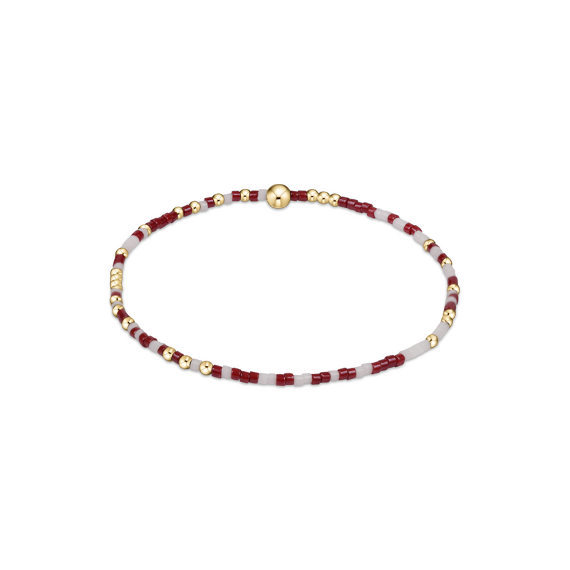 Beaded necklace with wine red, white, and gold beads on a white background