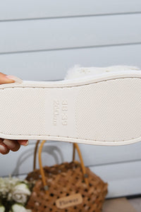 White sneaker being held with a blurred background