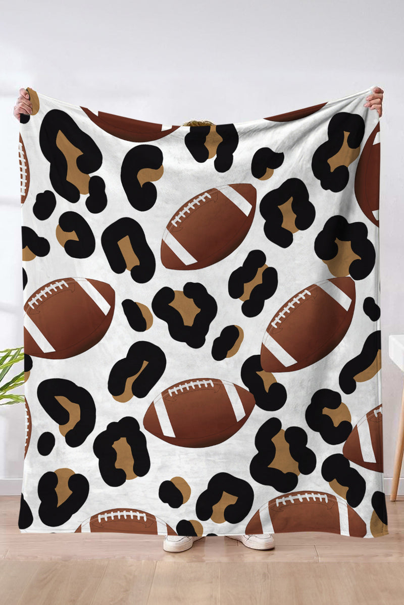 Blanket with football and leopard print pattern held by a person