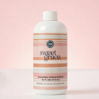 Sweet Grace Cleaning Concentrate bottle against a soft pink background with label detail