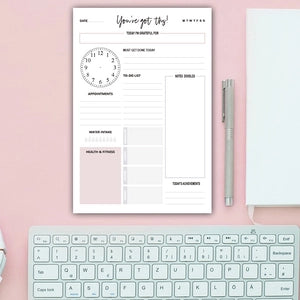 Daily planner sheet with habit tracker and pink color blocks