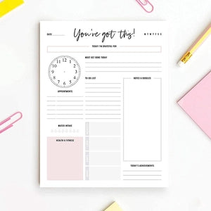 Pink daily planner notepad with schedule and task tracker