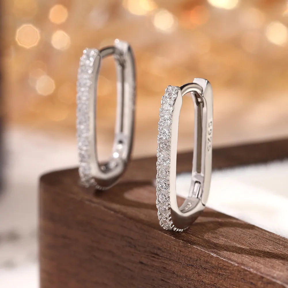 Macro view of sterling silver hoop earrings with white cubic zirconia stones