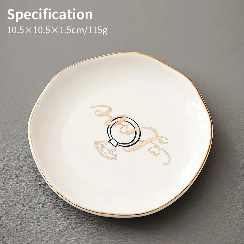 White ceramic jewelry dish with gold rim and a Love diamond ring print for trinkets