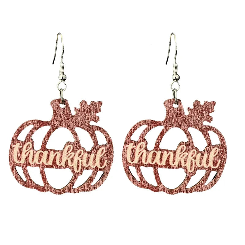 Brown wooden pumpkin dangle earrings with a thankful cut-out design for Thanksgiving