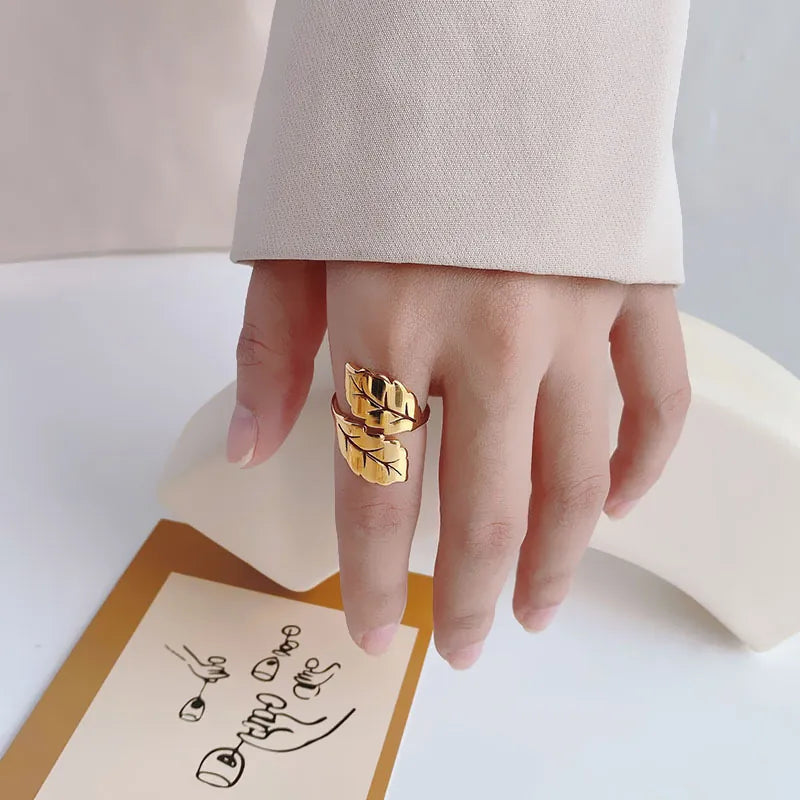 Gold double leaf open ring with textured veins and an adjustable band