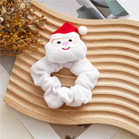 White plush hair scrunchie with a cute Santa Claus charm