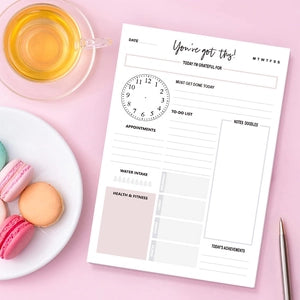 Minimalist daily planner notepad with hourly schedule and habit tracker