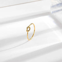 Gold titanium steel minimalist knot ring with a polished finish