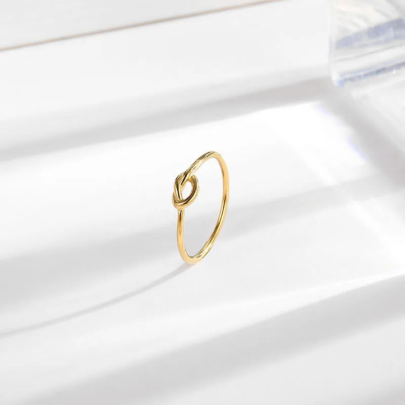 Gold titanium steel minimalist knot ring with a polished finish