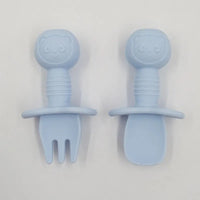 Light blue silicone baby fork and spoon set with panda design and safety guard