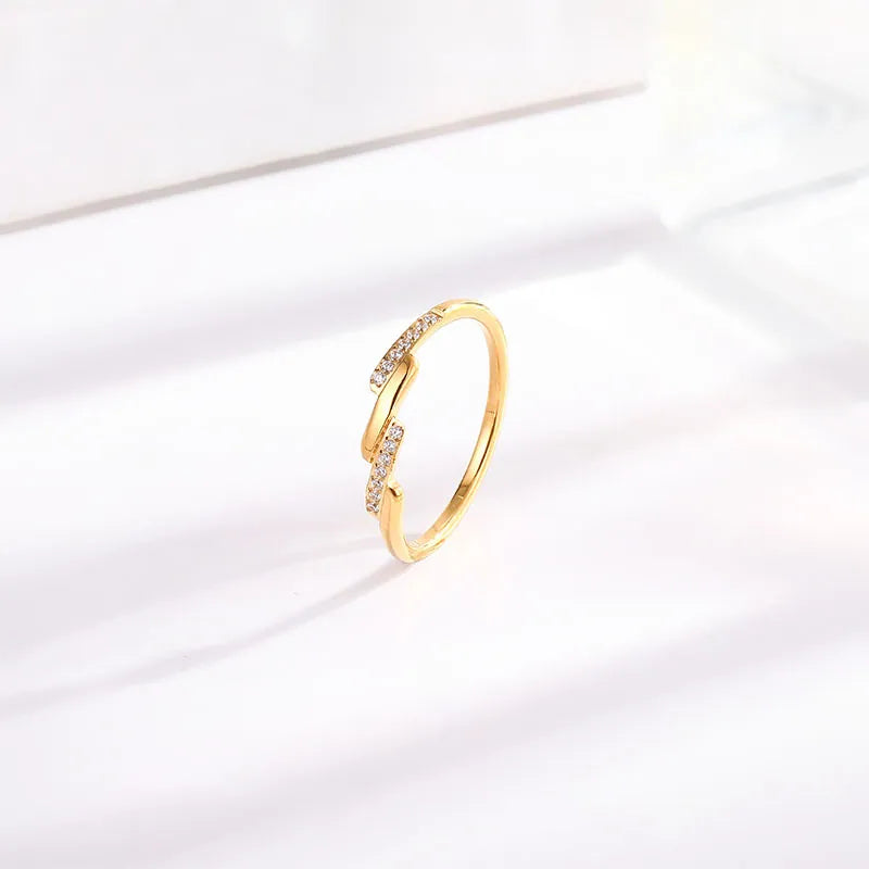 Gold titanium steel band ring with a diagonal row of pavé zircon stones