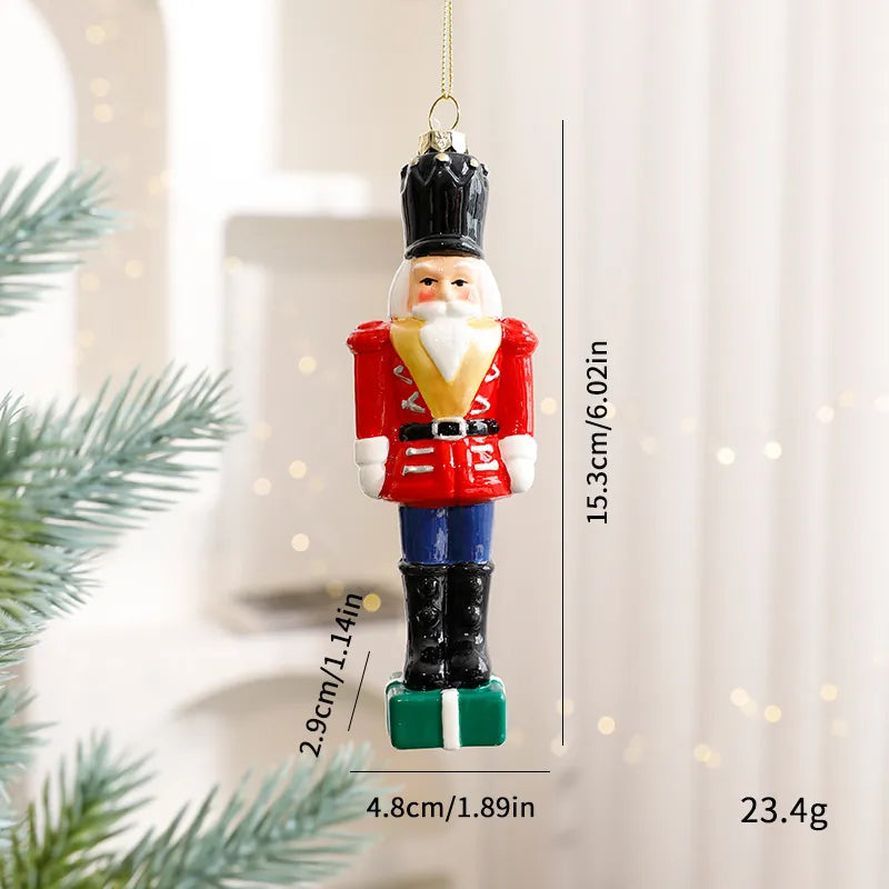Hand-painted glossy nutcracker soldier Christmas ornament in red uniform on a green gift box