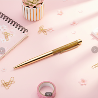 Product listing shopadelynes.com with a gold pen and glitter pen top