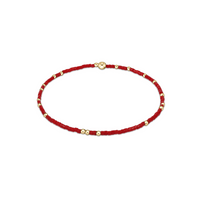 Red beaded bracelet with gold beads on a white background