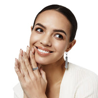 Model wearing a Brighton silver-plated band ring with scroll detail paired with silver-plated tassel drop earrings
