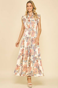 Woman wearing a floral dress against a beige background