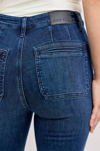 Close-up of blue jeans with a Judy Blue label on a white background