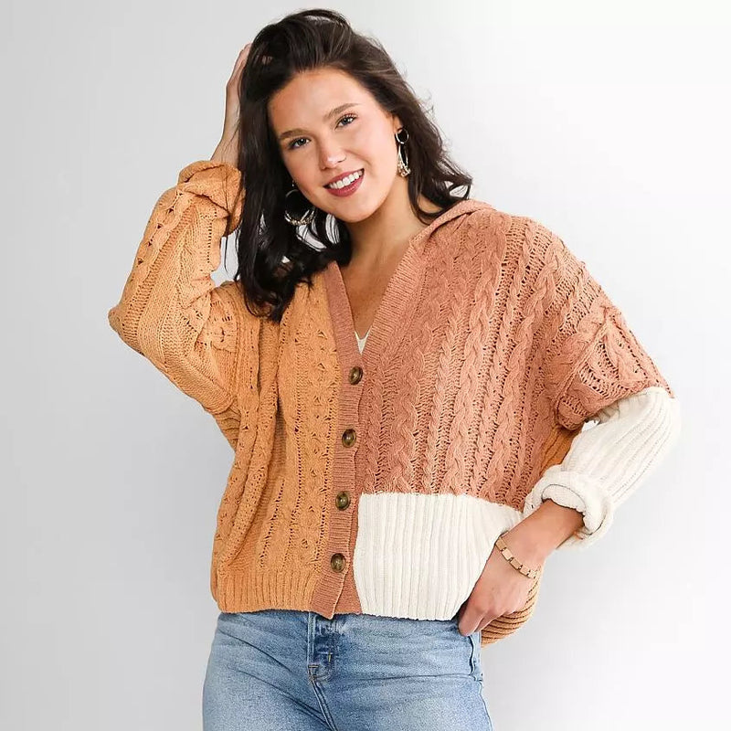 Woman wearing a two-tone cardigan with a white background