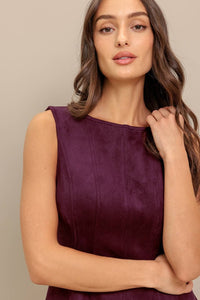 close up shot of a Woman wearing a purple sleeveless dress 