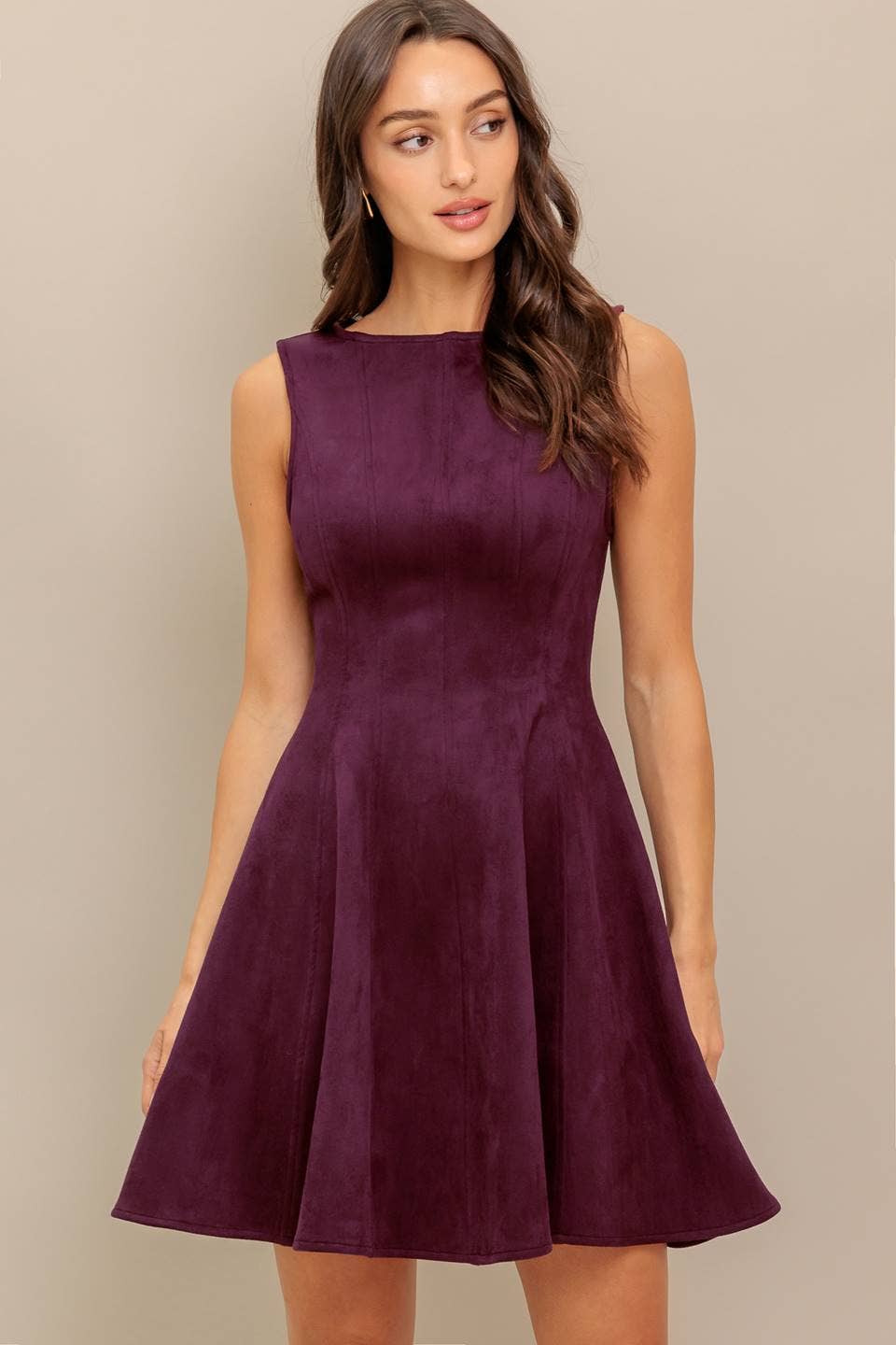 woman wearing a burgundy dress looking sideways