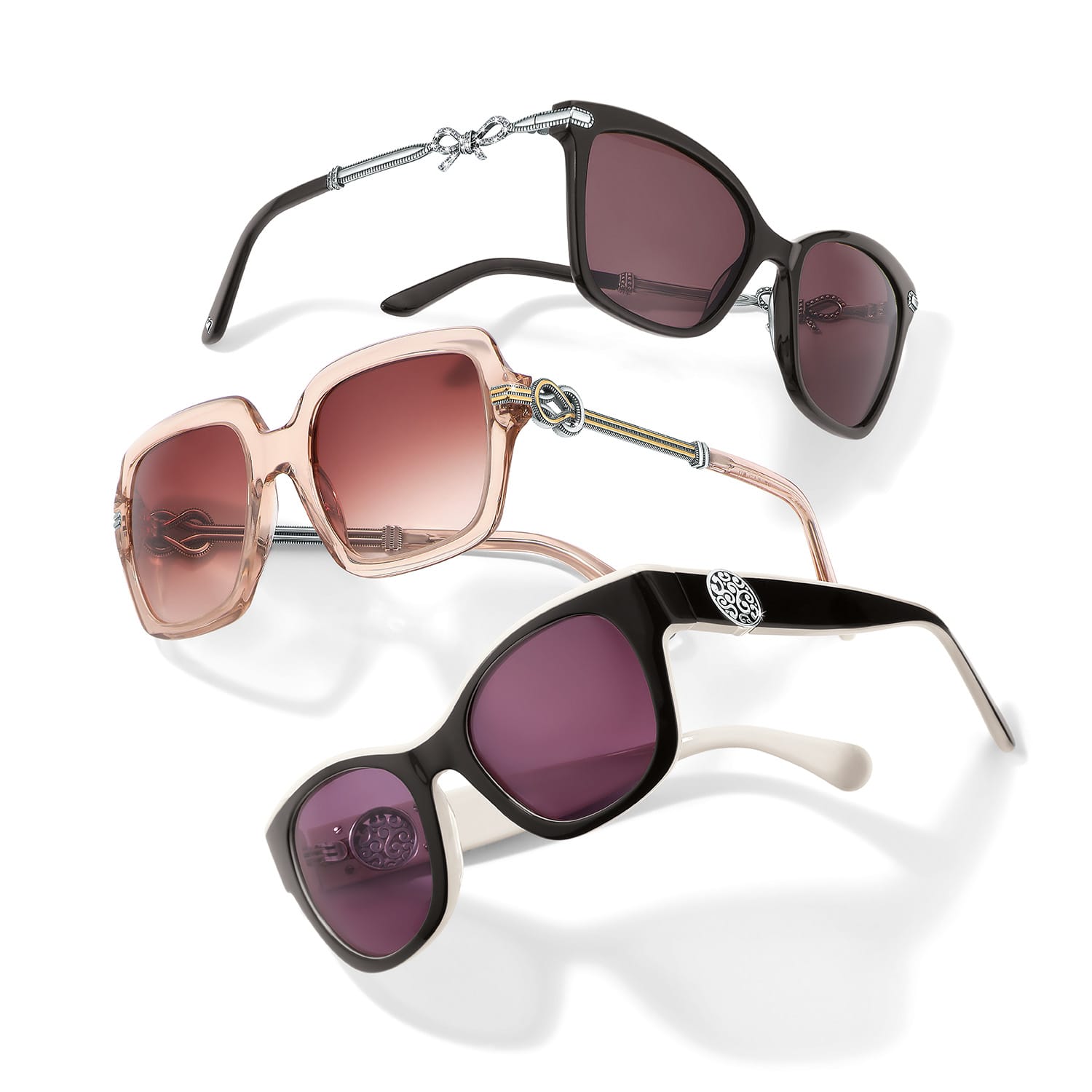 Brighton sunglasses trio in black, transparent pink, and black-and-white frames with silver-tone scroll accents