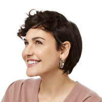 Model wearing Brighton silver-plated hoop earrings with black enamel detailing along the outer edge